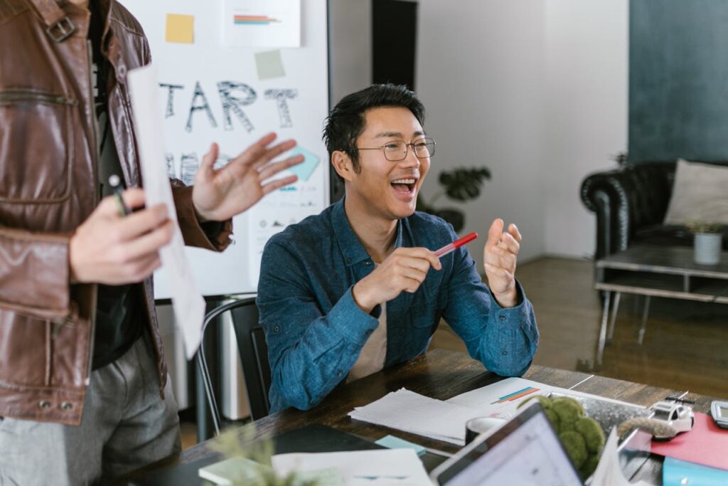 Branding for entrepreneurs. A happy asian man holding a red pen