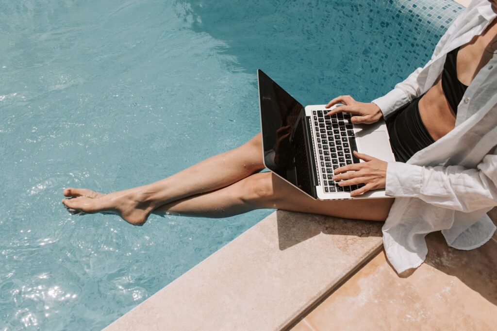 a woman sitting at the edge of a pool on a laptop. This is to give the perceived impression of the branding course online being a high value offering but at a very affordable cost.
