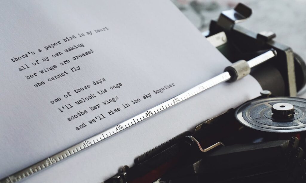 design trends for 2025 is about storytelling. This is a typerwriter with some writing on the paper that looks like a story it says 'theres a paper bird in my heart all of my own making her wings are creased she cannot fly one of these days i'll unlock the cage soothe her wings and we'll rise in the sky together.