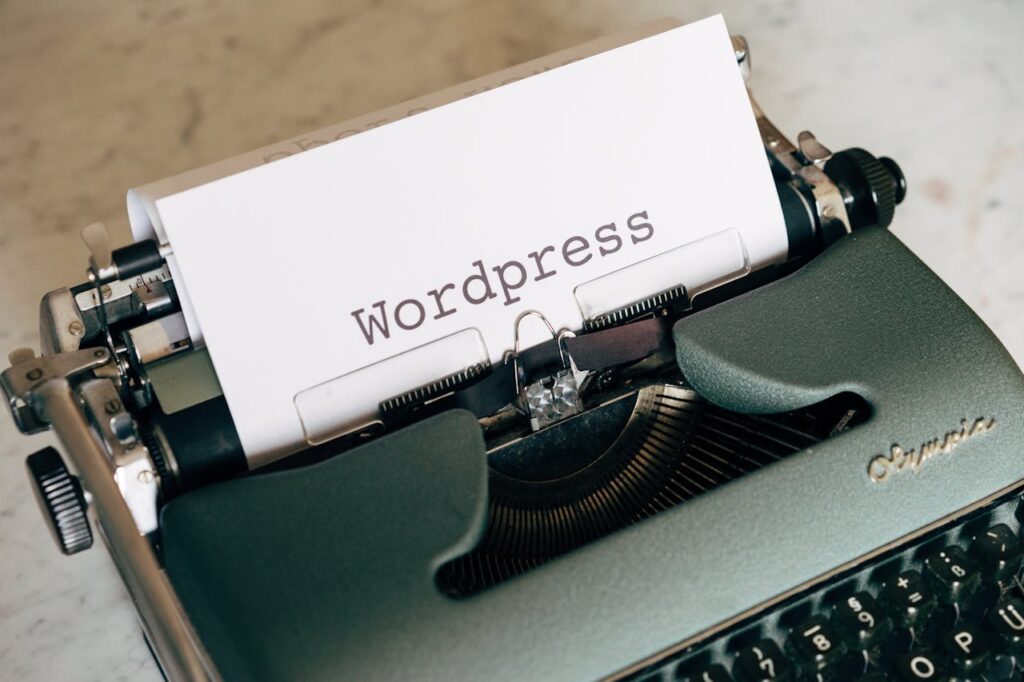 a typerwriter with the word WordPress typed out on a piece of paper that is fed into the typerwriter.
